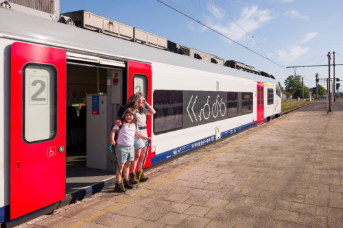 Photo de deux enfants devant un train à l'arrêt en gare